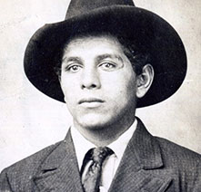 Historical portrait of Rufino Rodrigues in a suit, tie, and brimmed hat