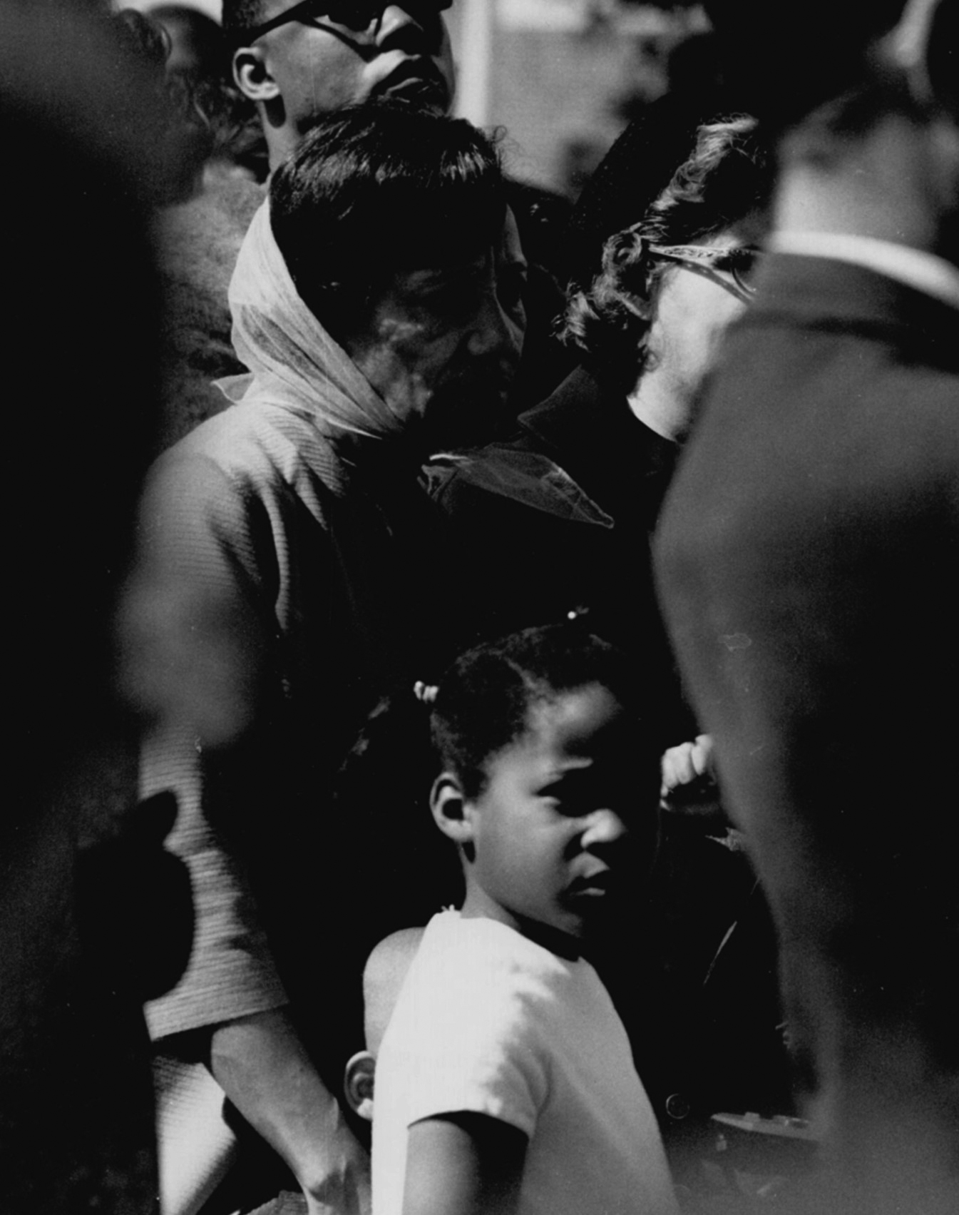 An older Black woman and a young Black child in a crowd of people. 