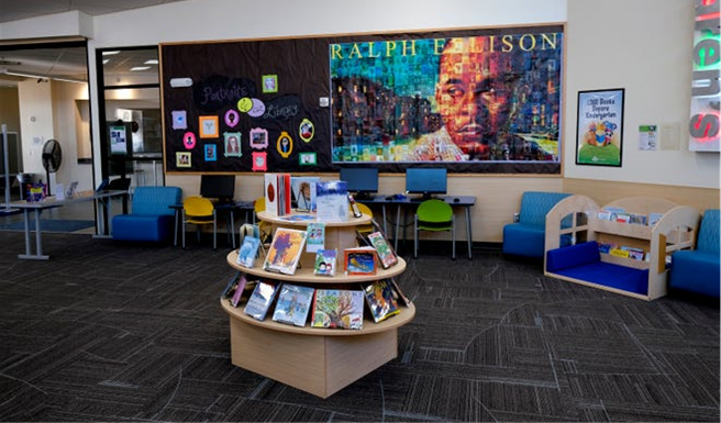 Art recreating the Ralph Ellison U.S. postage stamp is displayed on the wall of the Ralph Ellison Library.