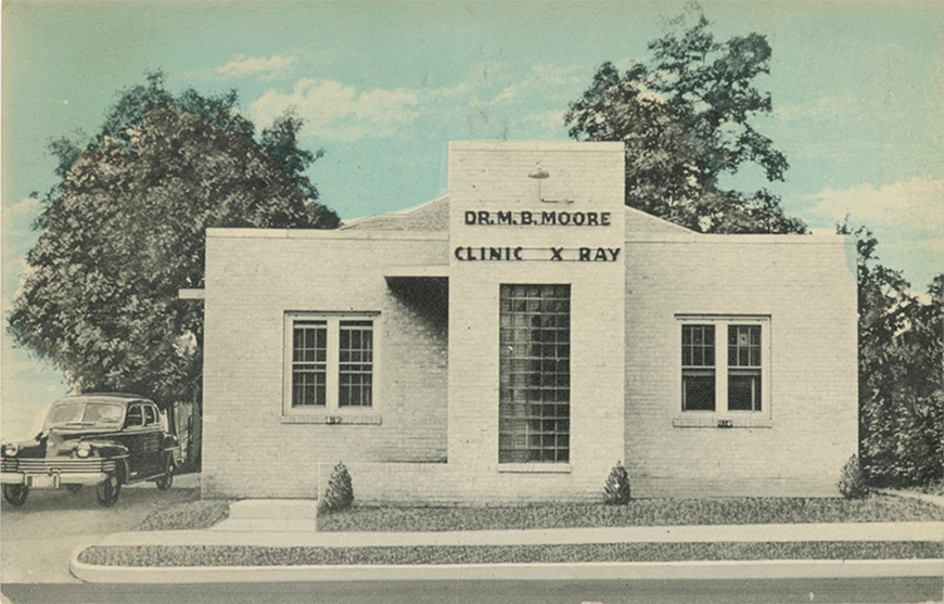 A postcard of a building with a sign reading, 'Dr. M. B. Moore, Clinic X Ray.'