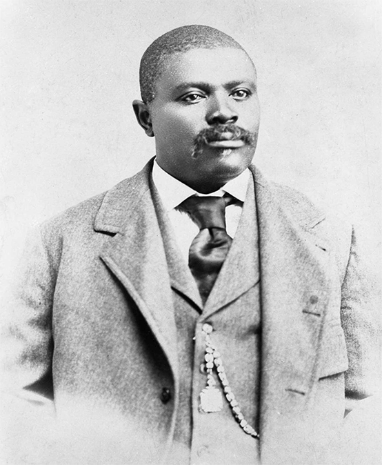 An African American man with a mustache in a suit.