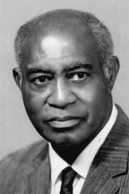 A Black man with gray hair wearing a suit. 