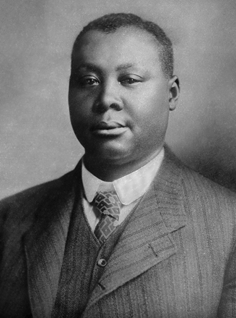 A photo of a Black man with short hair wearing a suit. 