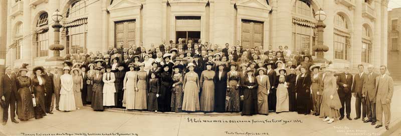 Panoramic group portrait of many people in front of a stately building. Text reads 89’ers Who Were in Oklahoma the First Year 1889.
