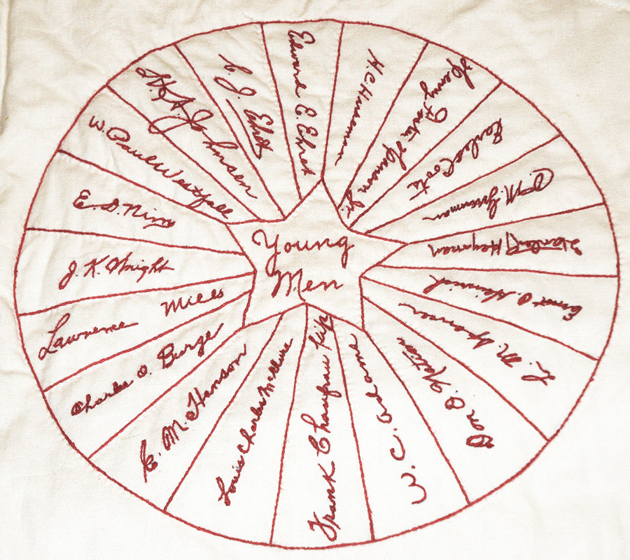 A square from the signature quilt featuring 20 signatures extending from a star in the center. Inside the star is the label 'Young Men.'