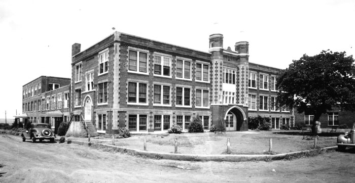 Wheatley Hall at Langston University is a large, multi-story brick structure with decorative brick work and an arched entry.