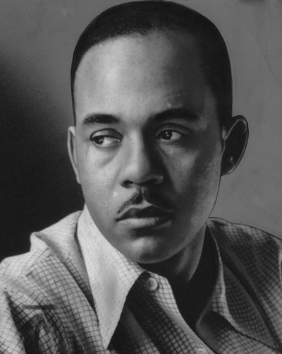A close-up portrait shows Ralph Ellison with a neat mustache looking to the side.