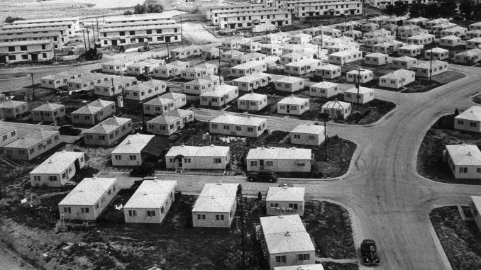 An aerial view of a neighborhood with approximately 80 buildings crowded together.  