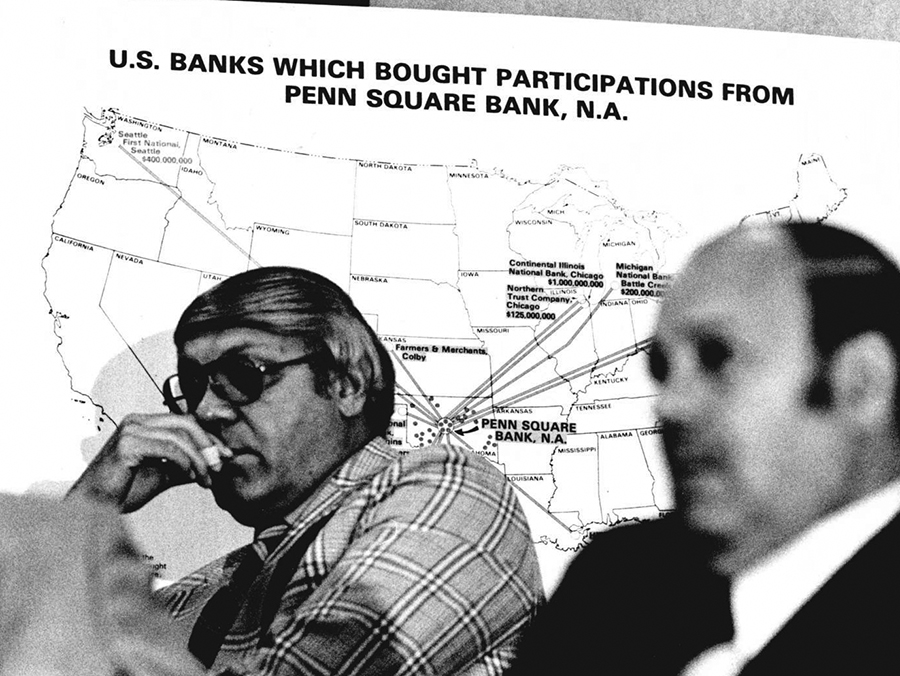 Two men sit in front of a map that reads, U.S. banks which bought participation from Penn Square Bank, N.A.