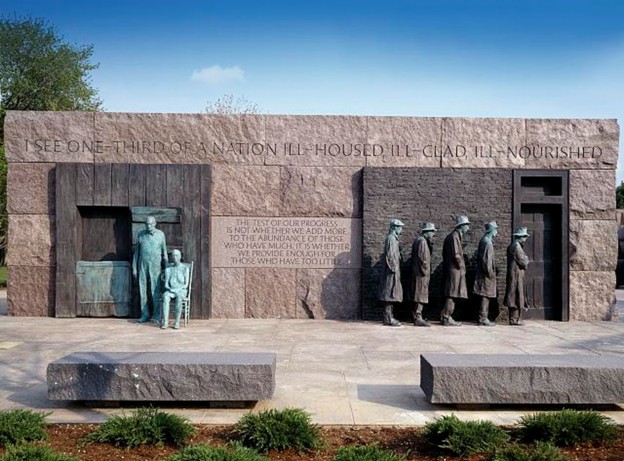 An outdoor installation with states of people standing in a line to receive food