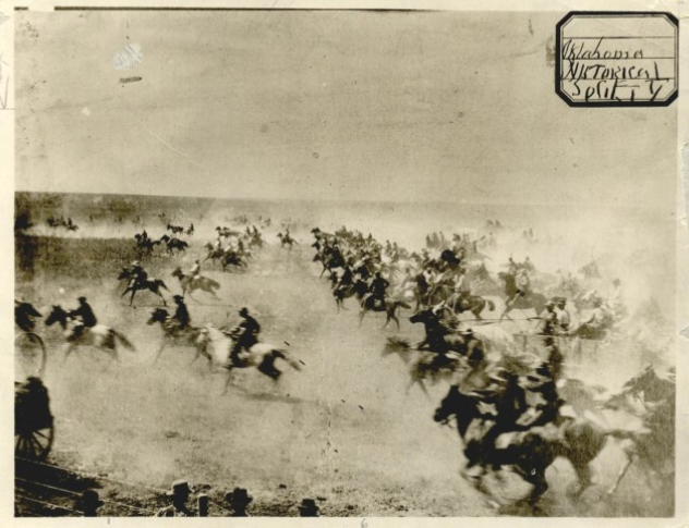 A large crowd on horseback race to make their claim
