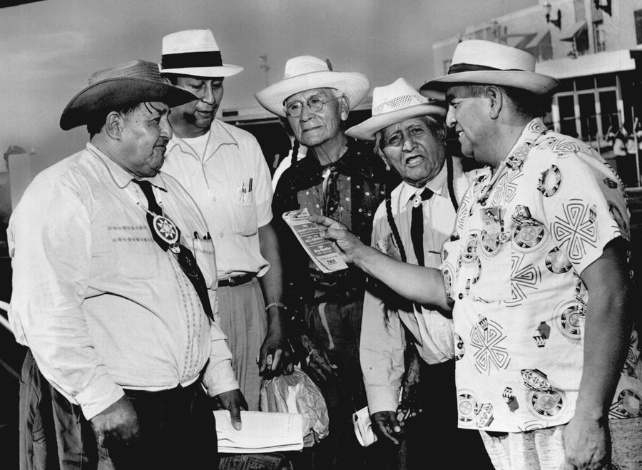 Five men in summer western wear stand together smiling.