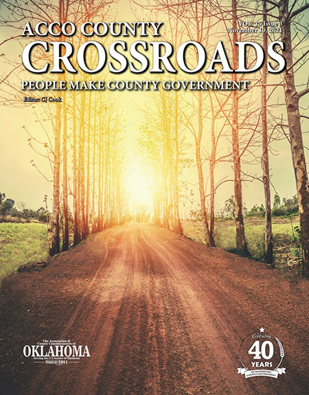 Cover of a magazine that shows a tree-lined dirt road at sunset. It reads ACCO County Crossroads. People make county government. 