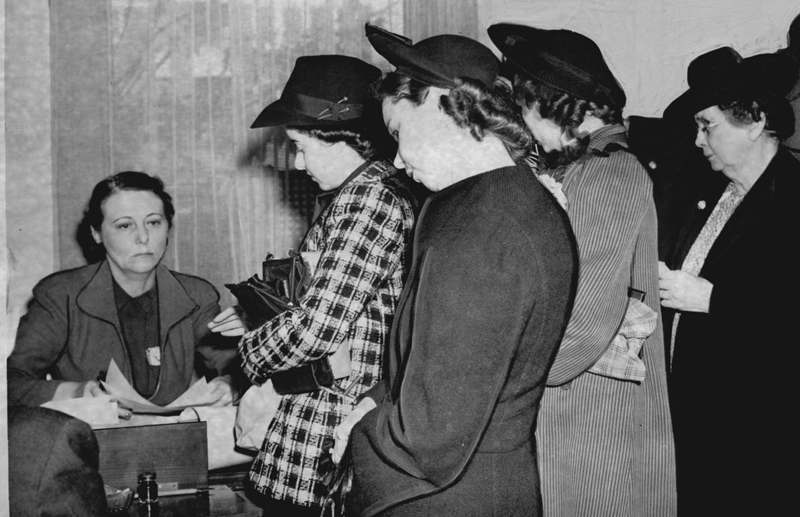 Women of varying ages stand in line to vote