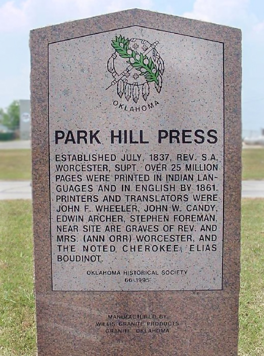 A red granite marker with text on a lighter background