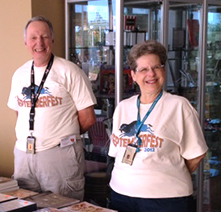 Two volunteers smile at the camera