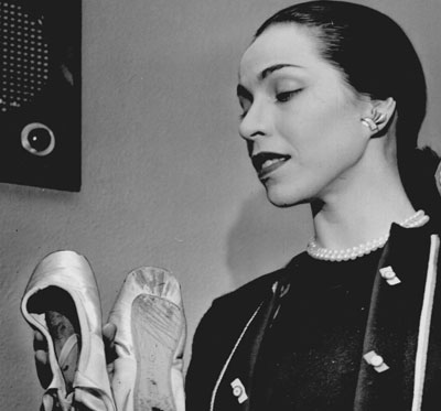 Profile of Maria Tallchief holding ballet slippers